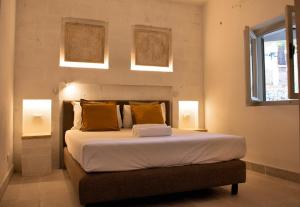 A bed or beds in a room at Gattarella Family Resort Puglia- Seaside Rooms and Suites with Premium Half-Board à la carte