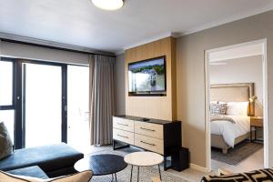 a bedroom with a bed and a living room at Santos Seaview Apartment in Mossel Bay