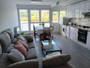 a living room with a couch and a table at Apartamento Ría Navia in Navia
