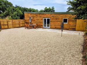 a log cabin with a patio and a table at Country Lodge Retreat in Lydney