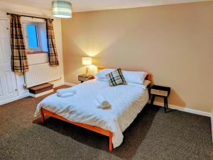um quarto com uma cama grande e uma janela em Country Lodge Retreat em Lydney