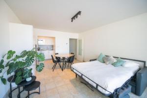 una camera con letto e tavolo con una pianta in vaso di cu@thesea a Ostenda