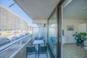 un balcone con tavolo e sedie e vista sulla città di cu@thesea a Ostenda