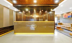 a lobby with a couch and a reception desk at Treebo Trend Spring Brook in Guwahati