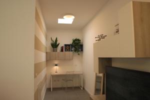 a living room with a desk and a tv at Magnolia Lake Como city center Free Parking in Como