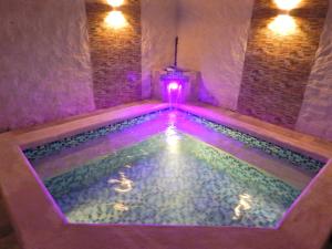 a swimming pool with lights in a room at B&B Villa CALASAN in Garzón