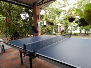 a ping pong table sitting on top of a patio at B&B Villa CALASAN in Garzón