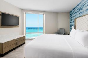 a bedroom with a large bed and a view of the ocean at Hyatt Place Panama City Beach - Beachfront in Panama City Beach