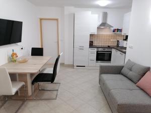 a kitchen and living room with a table and a couch at KIKA in Dramalj