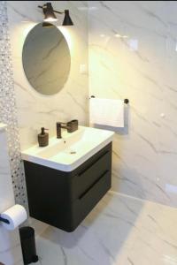 a bathroom with a sink and a mirror at Villa BO in Koprivno