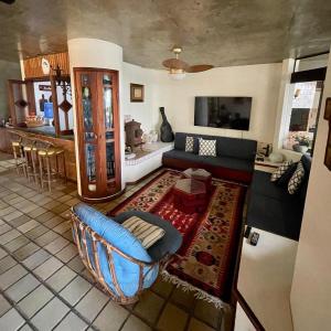 a living room with a couch and a table at Guaeca Villa in São Sebastião