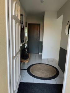 a hallway with a round rug on a tile floor at Villa du Golf Eden Parc in Lacanau-Océan