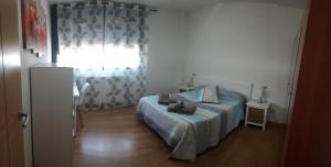 a bedroom with a bed and a window at El Descanso in Aínsa