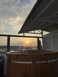 a large wooden barrel with the sunset in the background at Hotel Monte Carlo in Piteşti