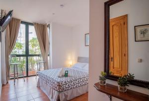 Postel nebo postele na pokoji v ubytování Hotel Doña Matilde