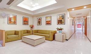 un soggiorno con divano e tavolo di Treebo Trend Galaxy Rooms a Nuova Delhi