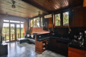 a kitchen with a sink and a couch and windows at Bali Ubud Villa View in Ubud