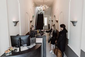 two women standing at a counter in a room at Châteauhotel De Havixhorst in Schiphorst