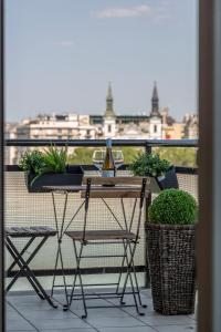 a balcony with a table and a glass of wine at Luxury Residence with a Beautiful view for the Danube River in Budapest