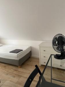 1 dormitorio con 1 cama y escritorio con ventilador en Hostel 19 Sopot en Sopot