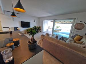 a living room with a couch and a table at House On The Sea Porto Rotondo in Porto Rotondo
