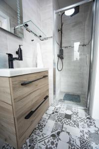 a bathroom with a shower and a sink at Half Door House in Dingle