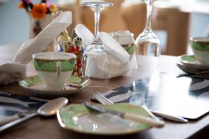 a table with plates and silverware on a table at Half Door House ROOM ONLY in Dingle