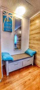 a bench in a room with a mirror on the wall at Tiny House Miniş in Miniş