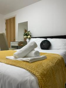 a towel sitting on top of a bed at Wharf Inn Premier Apartment Central Manchester - Free Private Parking in Manchester