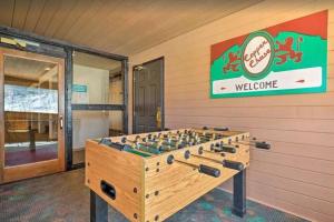 a foosball table in a room with a welcome sign at Mountain Getaway and Pool at Brian Head Ski Resort in Brian Head