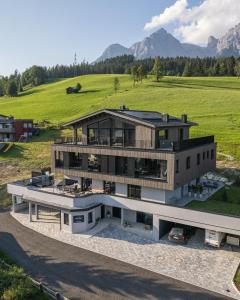 an aerial view of a house with mountains in the background at Bergleben Maria Alm - Haus Panorama in Maria Alm am Steinernen Meer