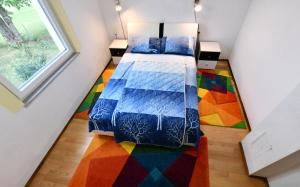 a bedroom with a bed with a colorful rug at Lora in Rakovica