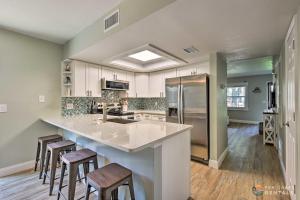 a kitchen with a large island with bar stools at Beachside Getaway with Private Fenced Yard & Fire Pit STEPS from Flagler Avenue! in New Smyrna Beach