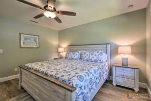 a bedroom with a bed and a ceiling fan at Beachside Getaway with Private Fenced Yard & Fire Pit STEPS from Flagler Avenue! in New Smyrna Beach