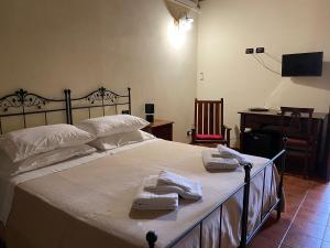 Postel nebo postele na pokoji v ubytování Agriturismo Il Melograno