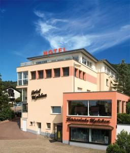 a hotel building with a hotel sign on top of it at Hotel Malchen Garni in Seeheim-Jugenheim