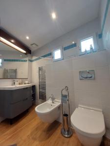 a bathroom with a toilet and a sink at Sea view front beach apartment deluxe near Nice airport in Cagnes-sur-Mer