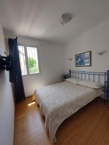 a bedroom with a bed and two windows in it at Sea view front beach apartment deluxe near Nice airport in Cagnes-sur-Mer