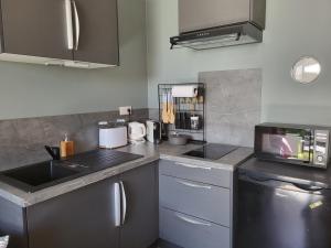 a kitchen with a sink and a counter top at Logement proche de Bordeaux, route des Châteaux in Ludon-Médoc