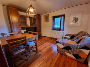 a living room with a table and a couch at APPARTAMENTO NONNA LEA in Alagna Valsesia