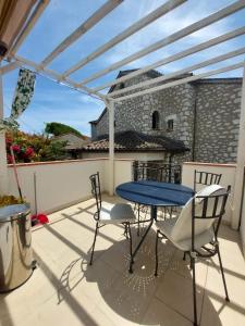 a patio with a blue table and chairs on a balcony at Sea view front beach apartment deluxe near Nice airport in Cagnes-sur-Mer