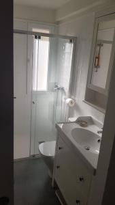 a white bathroom with a sink and a toilet at Apartamento Vadillos - VuT 09-401 in Burgos