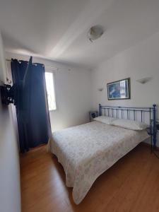 a bedroom with a bed and a window at Sea view front beach apartment deluxe near Nice airport in Cagnes-sur-Mer