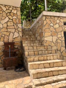 a set of stairs with a stone wall at Vila Razic in Danilovgrad