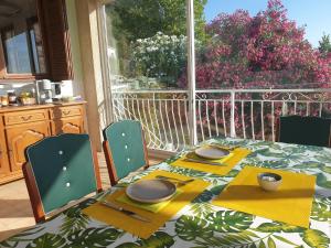 a dining room table with a view of a balcony at Chambres d'hôte A Caserella, Maison de village rénovée avec vue sur mer in Valle-di-Campoloro
