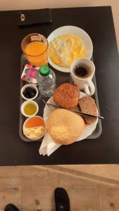 a table with a tray of breakfast foods and drinks at French Apartment With restaurant in Taourirt