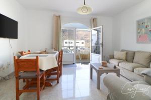 a living room with a table and a couch at Cliff View Orzola in Órzola