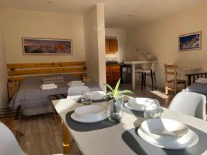 a kitchen and living room with a table with plates on it at Chaltén Mountain Lofts 1 in El Chalten