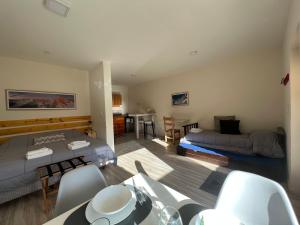 a living room with two beds and a dining room at Chaltén Mountain Lofts 1 in El Chalten