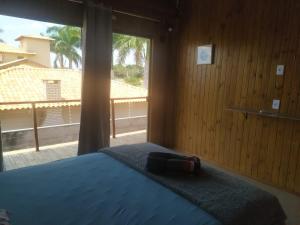 a bedroom with a blue bed with a large window at Formosa Suites in Bonito